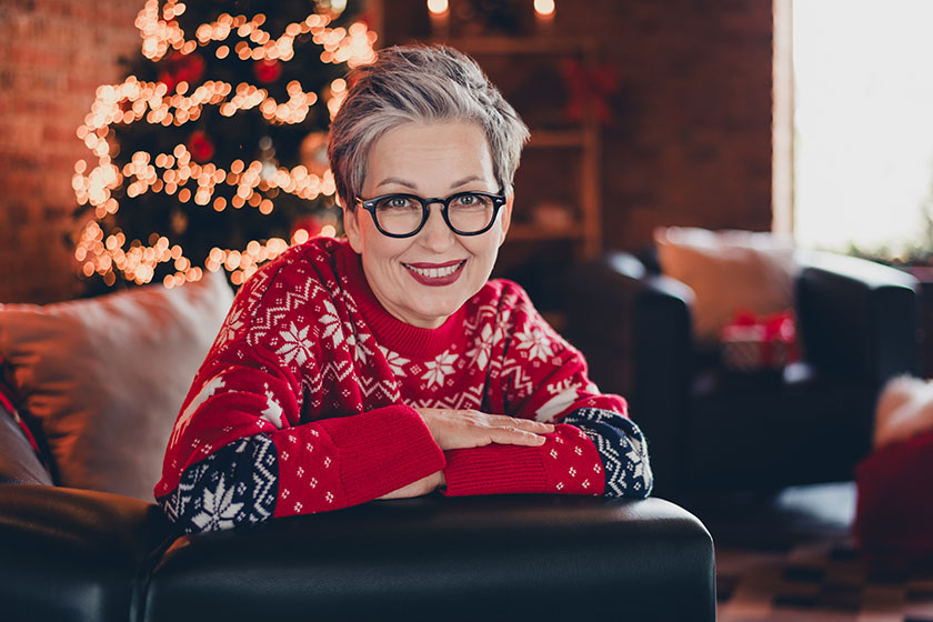 Portrait of cute beautiful retired woman white hair grandmother red sweater